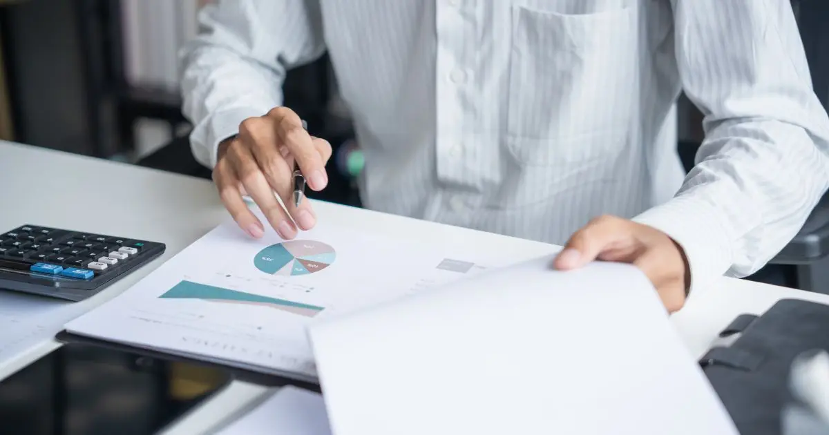 Business owner reviewing financial documents at a desk, illustrating the gap between perceived and actual business value